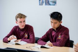 Two high school students discuss a text.
